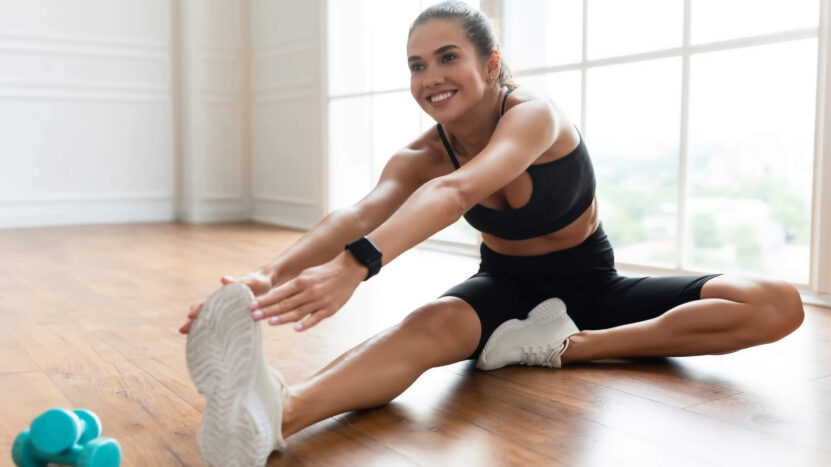 A girl is stretching her hamstring