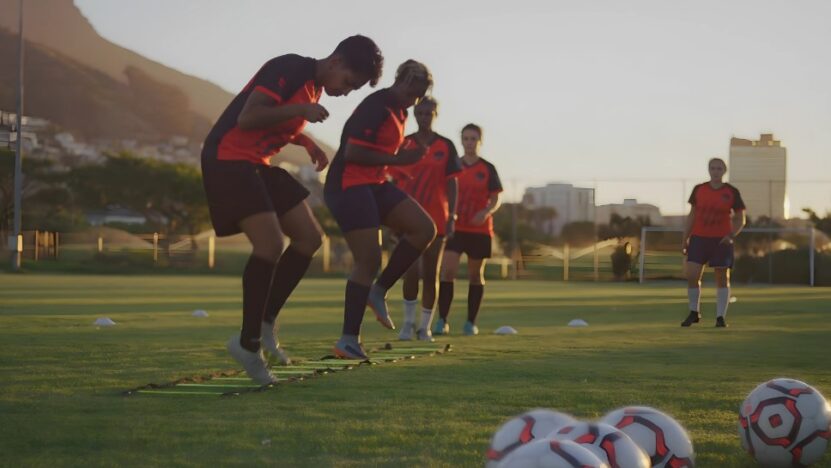 Soccer players doing ladders at practice