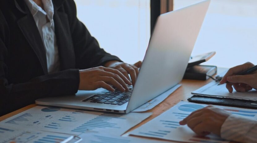 Two persons in office making financial plans